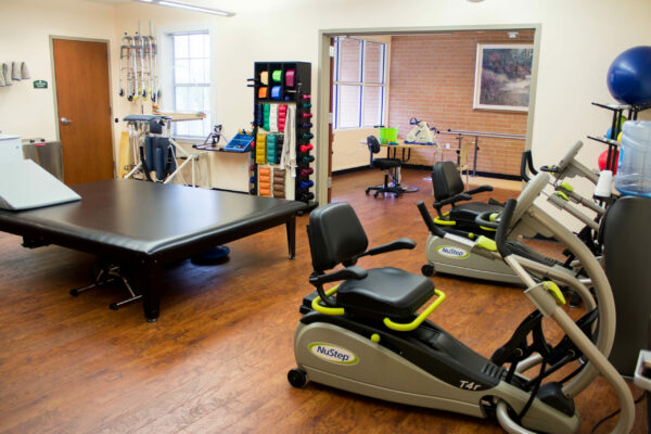 Physical Fitness room full of equipment in senior care community.