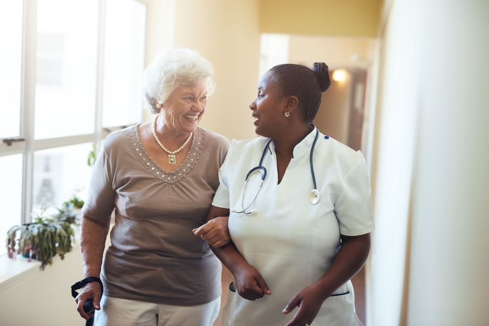 Woman Walking Through Assisted Living Facility