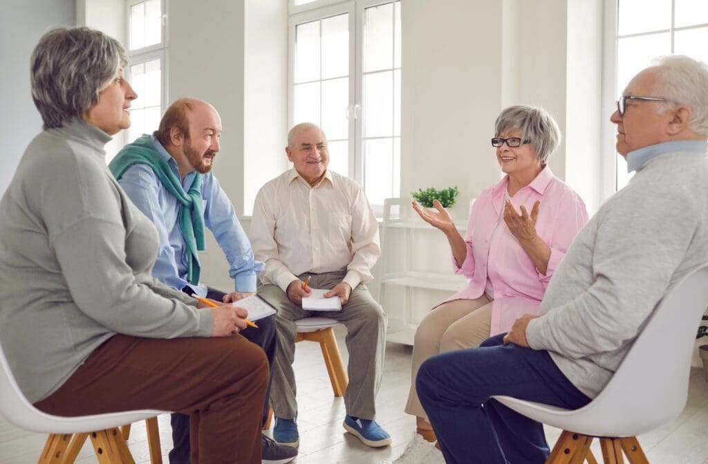 Community, Care, and Connection: What Sets Christian Retirement Homes Apart 1 Smiling senior woman attending Bible study with friends in a welcoming Christian retirement home community